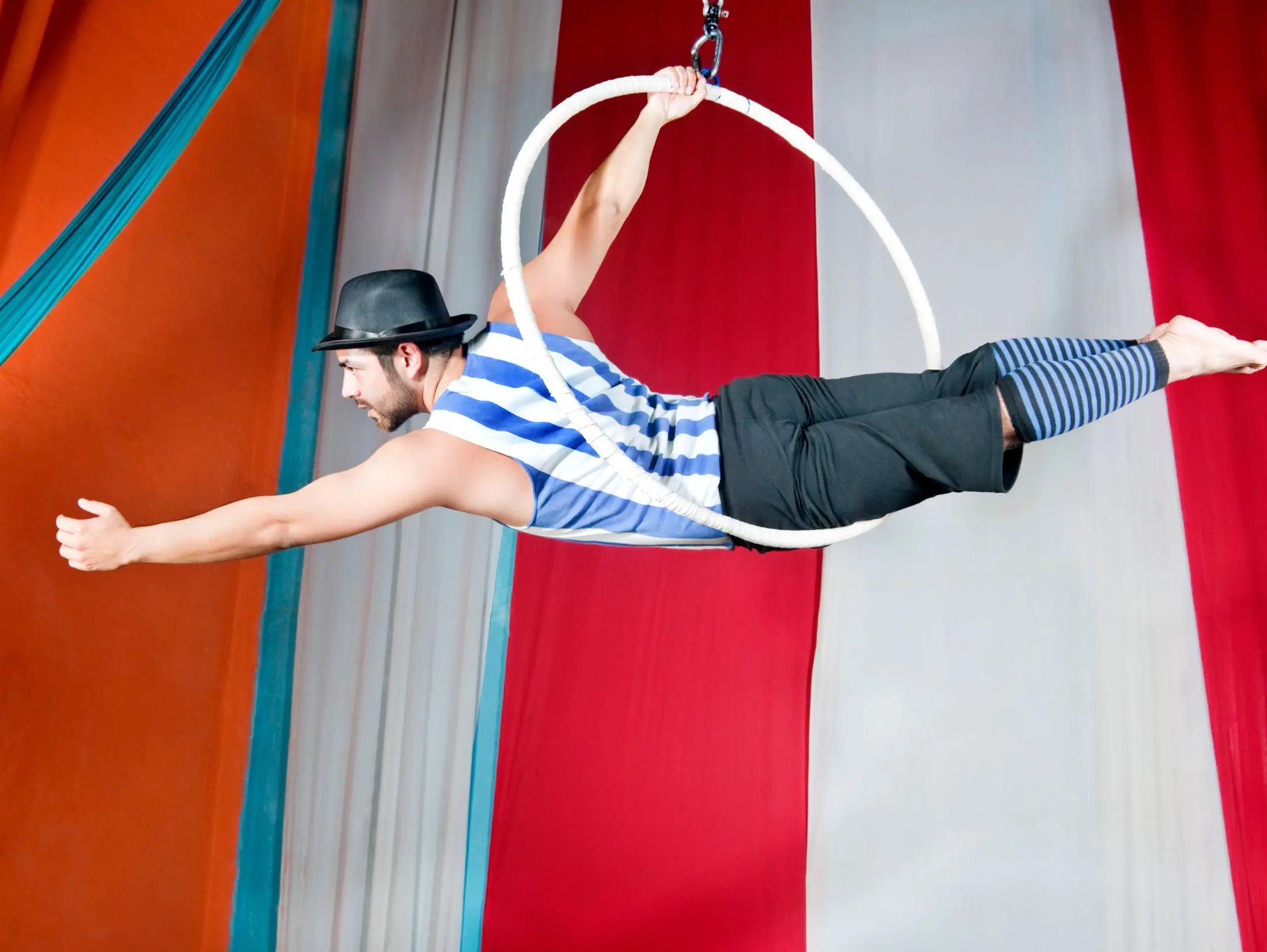 Circus performer on a trapeze horizontally